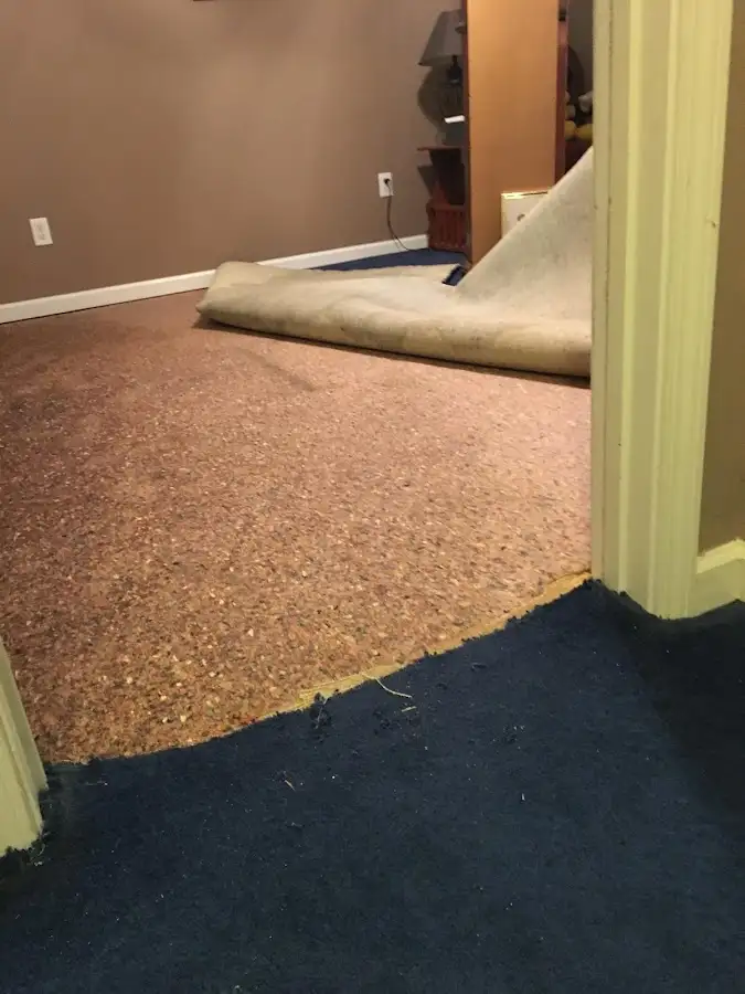 Carpet pad removal revealing water damage during Drying & Dehumidification in Dodge City
