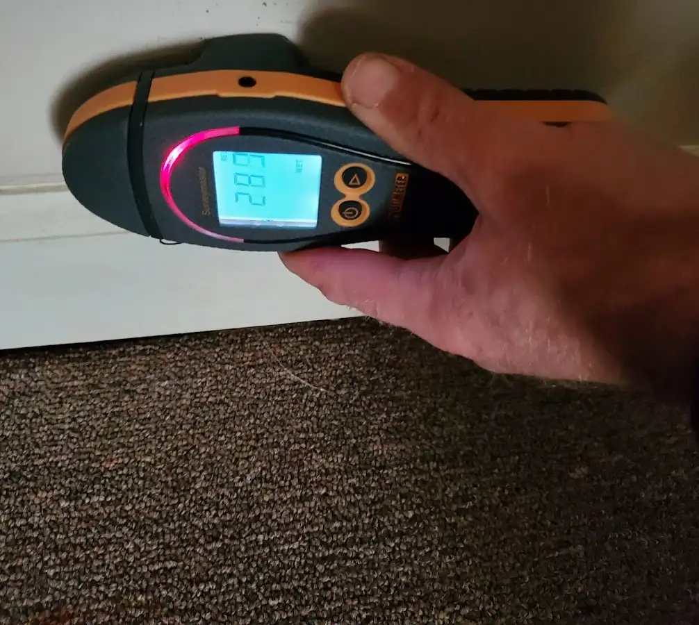 Moisture detection at baseboard during Storm Damage Restoration in Dodge City